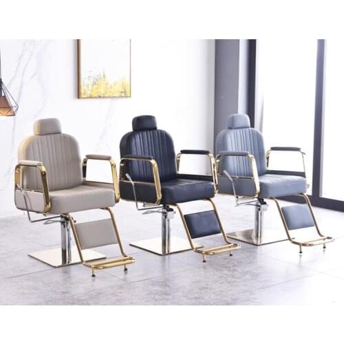 The golden hairdressing chair can be reclined. Barbershop chair and hair salon can be lifted and reclined