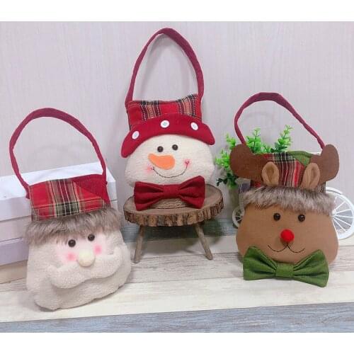 Santa Claus carries a bag of Christmas Eve presents and Christmas decorations