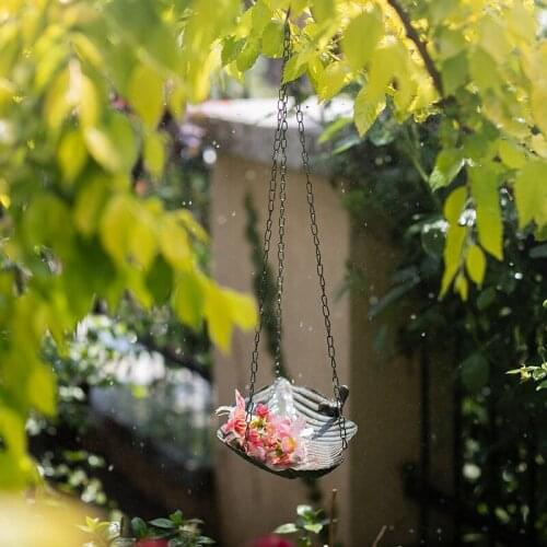 Rusty retro metal bird feeder from leaf plate