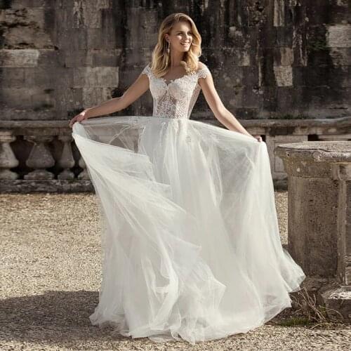 Latest Modern Ivory Lace Cap Sleeves Bridal Wedding Gowns Illusion Jewel Neck Sheer Back Appliqued Wedding Dress for Bride 2021