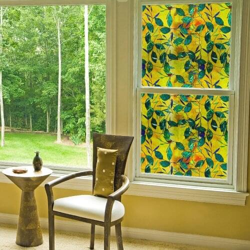 Flower shadow electrostatic film in front of green leaves at sunset and dusk opaque office window glass sticker
