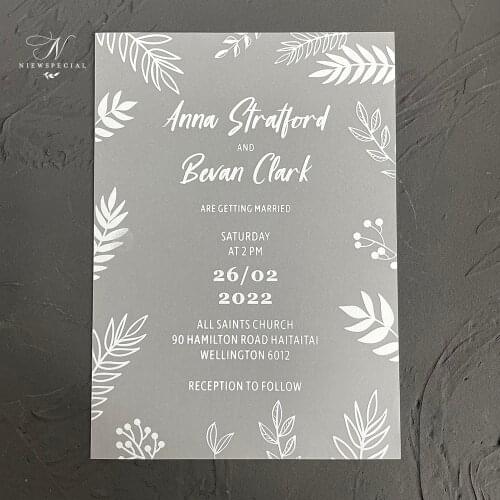 White vellum paper invitation with leaf design