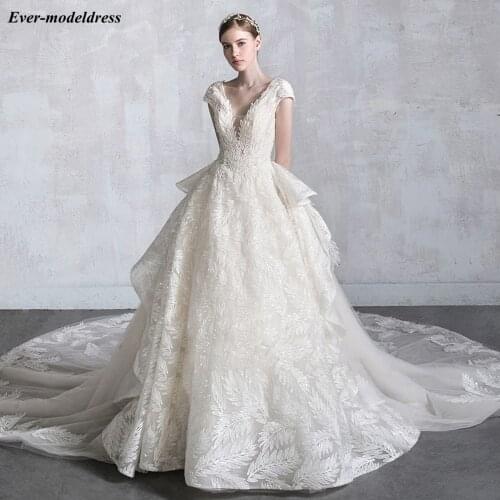 Luxury Sparkly Lace Wedding Dresses 2020 V Neck Short Sleeve Sequins Open Back Chapel Train Overskirt Bride Gowns Robe De Mariee