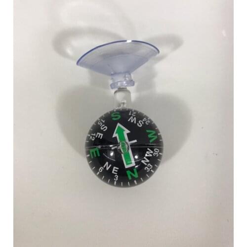 Black color small compass with suction cup attached to the interior glass