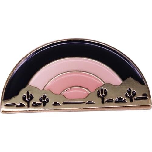 Keep the desert close to your heart with this pin inspired by its blushing skies and sinking sun
