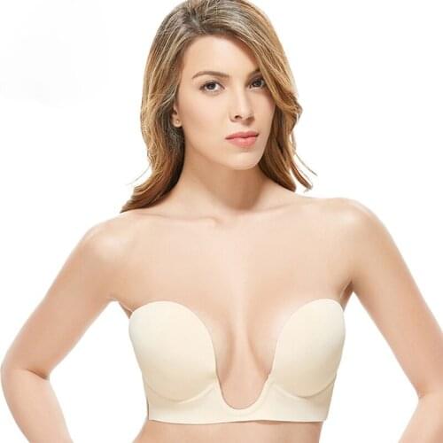 A one-piece deep U silicone bra flanking an invisible breast strap and strapless bra