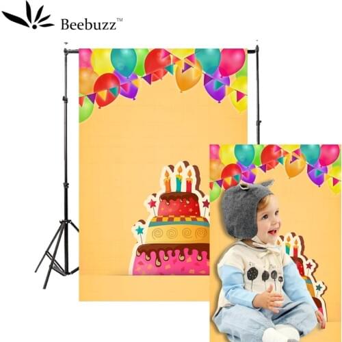 Children celebrating birthday on yellow background photography studio photophone Balloon cake pattern party photo shoot