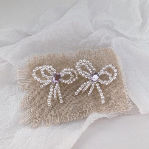Fashion exaggerated jewelry super fairy double bow pearl earrings star with the same design retro sweet girl earrings wholesale
