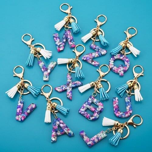 1pcs Women Keychains 26 Glitter Hollowed-out Words Handbag Tassel English Letter Keyring with Puffer Ball Charms