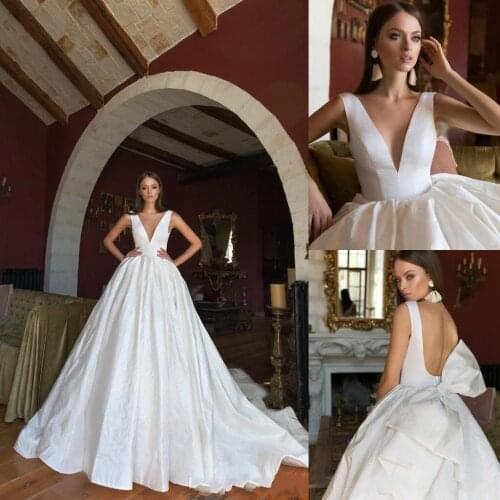 Bohemian Ball Gown Wedding Dresses V Neck Backless Sleeveless Sweep Train Country Bridal Dress Bow Plus Size Vestido De Noiva