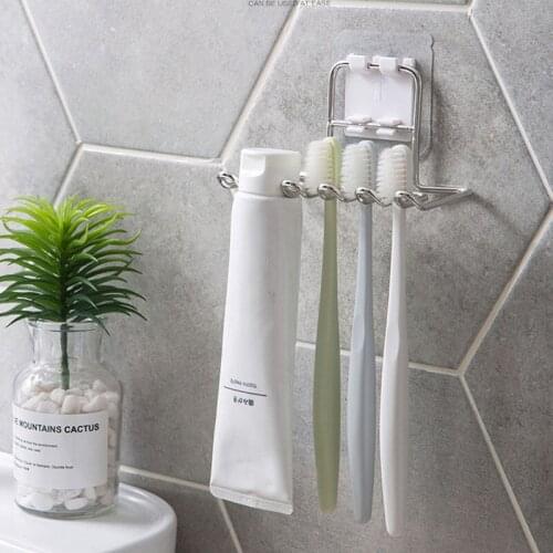 Stainless steel frame free punching toothbrush razor shelf bathroom wall hanging creative toothbrush and toothpaste rack