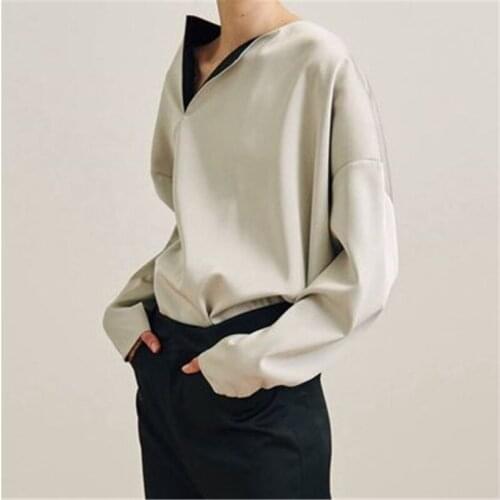 Glossy textured asymmetrical top with a collared cream shirt