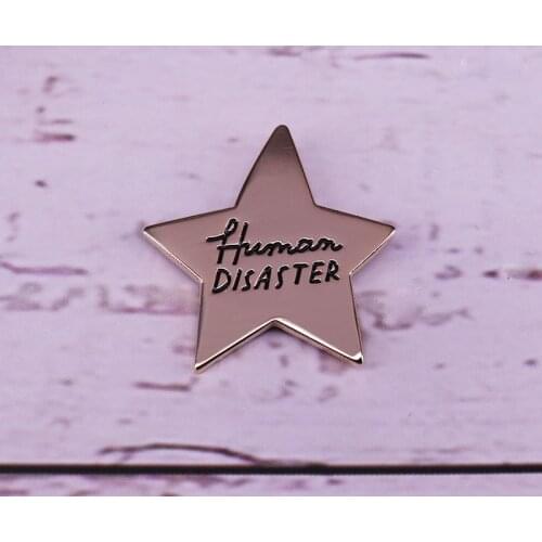 Human Disaster gold star enamel pin