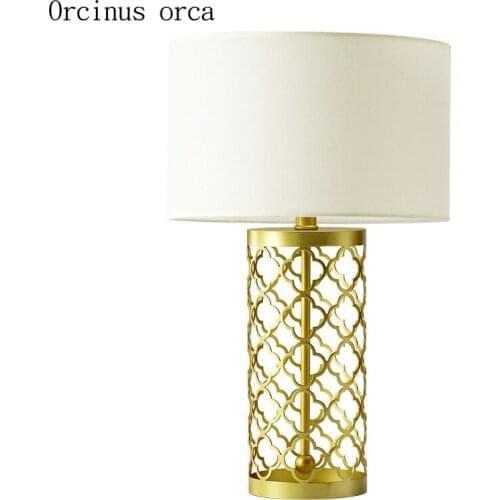 American modern simple golden table lamp living room bedside lamp post modern creative personality LED hollow iron desk lamp