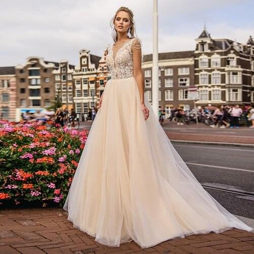 Champagne Bohemian Wedding Dresses with Beadings Chic Lace Applique Illusion V-neck Buttons Back Sweep Train Formal Bridal Gowns