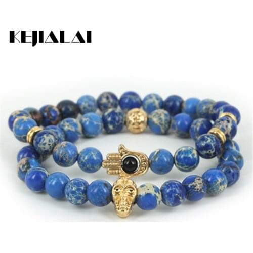 KEJIALAI 2pcs Beaded Gold Skull Head Charm Men Bracelet Natural Blue Regalite Round Stone Beads Women Hamsa Hand Bracelet A0570