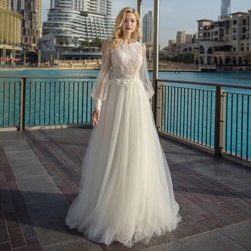 A-Line O-Neck Lantern Long Sleeve Wedding Dresses 2021 Lace Appliques Sweep Train Tulle Boho Bridal Gown With Button Back