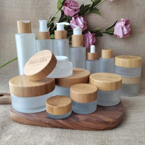 Customized Logo Makeup 100g Glass Container Cream Jar With Bamboo Lid Skin Care Packaging Empty Frosted Glass Cosmetic Pots