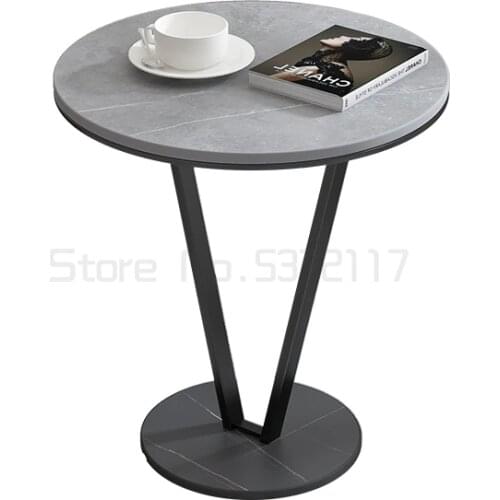 The luxurious side table is a small round table next to the sofa in the living room. The marble corner table is a coffee table