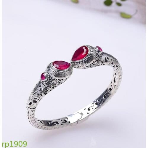 KJJEAXCMY boutique jewelry S925 sterling silver jewelry spring ladies hollow cut surface red corundum green crystal bracelet