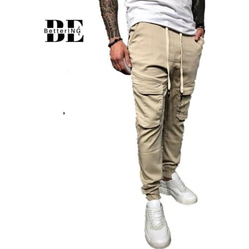 Mens new slimming sports trousers in 2021. Micro stretch wide trousers with small legs. Casual solid multi-pocket overalls