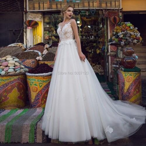 Unique Champagne A Line Wedding Dresses with Ivory Appliques Sexy Sheer Scoop Neckline V Back Court Train Bridal Gowns 2020