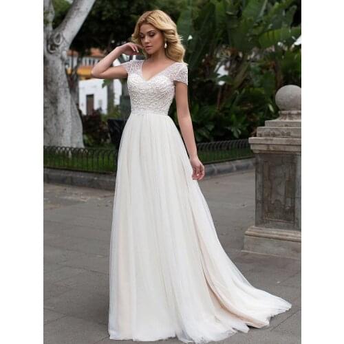 2021 A-Line Wedding Dresses Sexy V Neck Appliqued Cap Shoulder Backless Illusion Beading New Floor Length Bridal Gowns