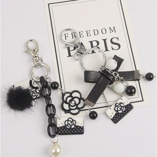 Korean version of small incense pearl mountain tea flower keychain chain four-leaf grass classic retro hand-custom black