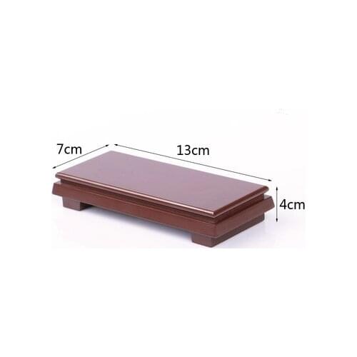 Rectangular artwork of ceramic purple clay pot on living room bracket with miraculous stone base on imitation wood, mahogany and