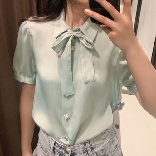 ZA2021 summer new womens clothing belt Pearl single-row bow pure color bubble sleeve shirt