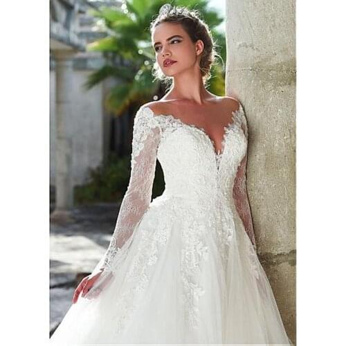 Marvelous A-Line Illusion Wedding Dresses Long Sleeve Lace Appliques Sexy Backless V-Neck Elegant Boho Beach Bridal Dresses 2021