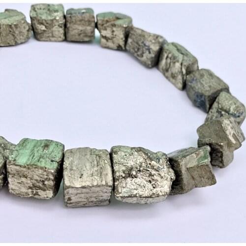 Collecting specimens of natural chalcopyrite blocks for teaching raw ore