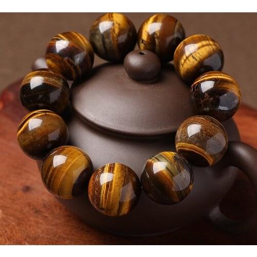 Natural tigers eye stone bracelet, Buddhas bead and hand string to attract wealth and transport yellow tigers eye jewelry