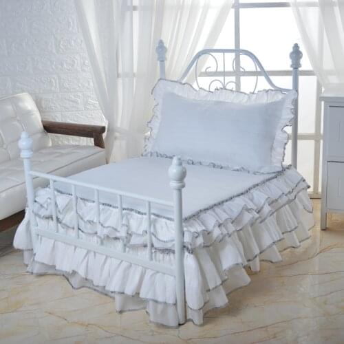 White wrought iron pet bed with pure white bedding