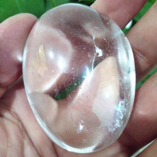 A Natural quartz crystal palm stone with rainbow yoga practice plaything chakra healing crystals