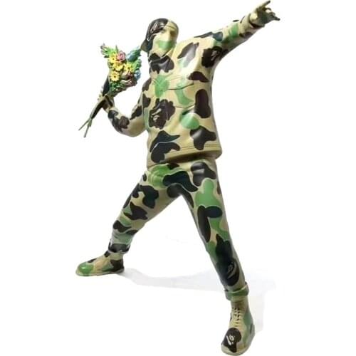 Banksys camouflage flower throwing bombers and elephant sculptures