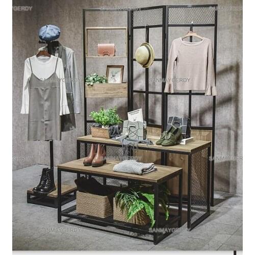 Clothes hangers. Display rack floor-mounted wheeled retro womens clothing store shelves. Iron side hanging decorative