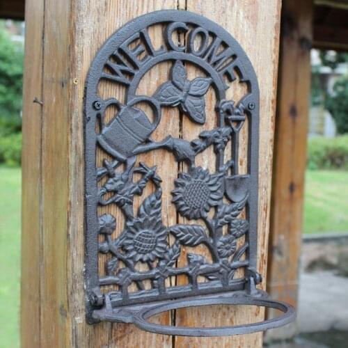 Antique Black Cast Iron Wall Flower Pot Rack With Welcome Signs and Butterfly Sunflower Watering Pot On Garden Wall Plant Holder