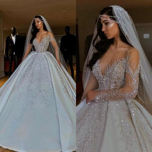 Luxurious New 2020 African Wedding Dresses Sheer Neck Long Sleeves Bridal Dresses Beaded Sequins Satin Wedding Gowns