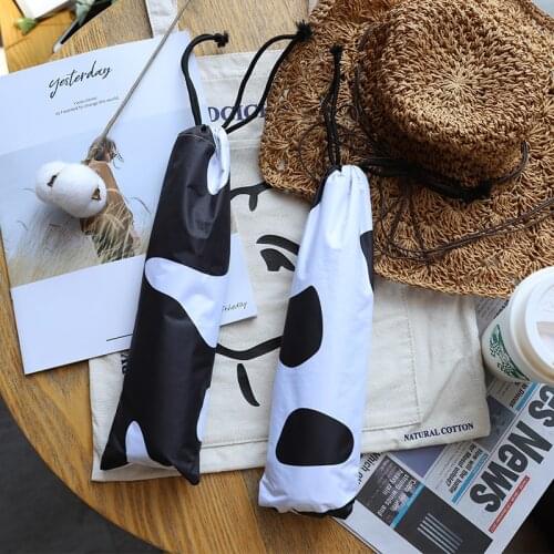 Black and white cow spot umbrella ultra light carrying sunny and rainy black plastic sunshade triple fold sunshade female