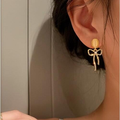 U-Magical Temperament Bowknot Dangle Earring for Women Charming Rhinestone Hollow Pearl Oval Opals Metal Earring Jewellery