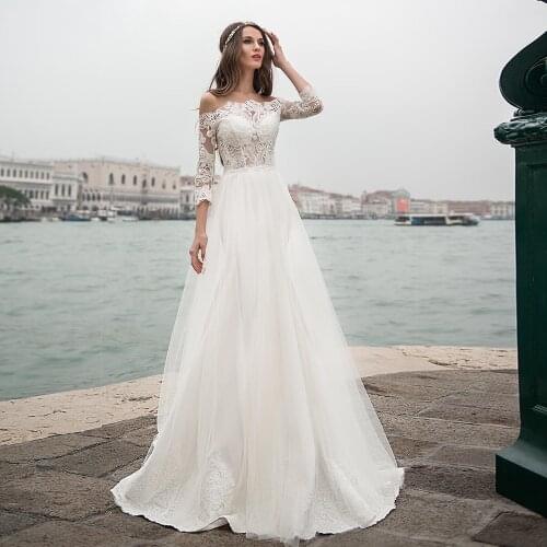 Sexy Boat Neck Wedding Dresses Lace Appliques Long Sleeves Boho Tulle Formal Bride Gowns with Buttons Back Sweep Train 2021