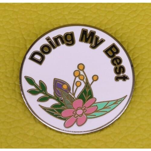 A floral motivational button badge that reminds you that you are doing your best