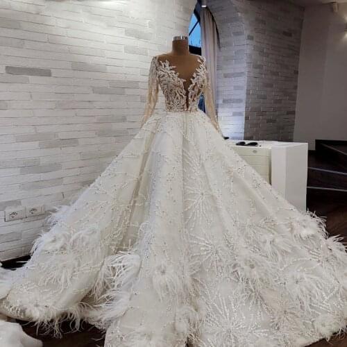 Amazing Feather A Line Wedding Dresses Sheer Neck Sheer Long Sleeves Applique Beads Sweep Train Wedding Vestidos Custom Made