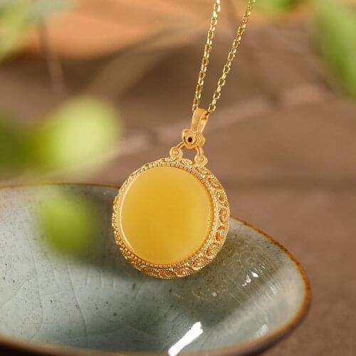 Natural 925sterling silver gilt gold inlaid amber hollow out pattern retro temperament can be opened sachet pendant luxury