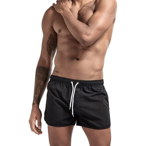 Men Fashion Beach Shorts Polyester Quick-drying Solid Color Sports Costumes Elastic Waistband with Drawstring Three-point Shorts
