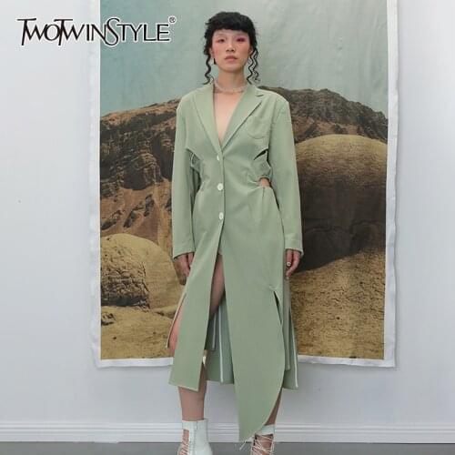 TWOTWINSTYLE Irregular Split Windbreaker For Female Lapel Collar Long Sleeve High Waist Hollow Out Drawstring Trench Coats Women