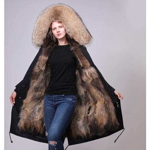 A coat of a natural sweater is a long coat with a woman and a pet park