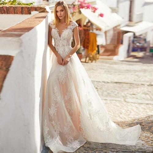 KapokDressy Illusion O Neck Cap Sleeves Button A-Line Wedding Dresses Appliqued Beaded 2021 New Floor Length Bridal Gowns