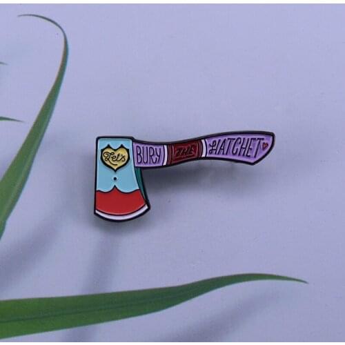 Want to make up with someoneGive them this Bury The Hatchet enamel pin and break the ice
